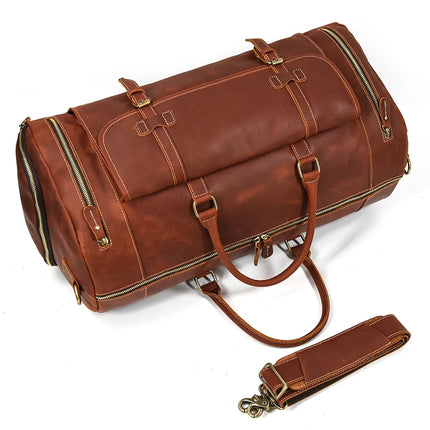 The Weekender 23 Leather Travel Bag is a spacious, brown bag crafted from genuine cowhide leather. It features numerous zippers, buckles, and handles, along with a detachable shoulder strap on the front. The brass hardware and detailed stitching add to its classic, rugged appearance. Additionally, the bag includes a dedicated shoe compartment for added convenience.