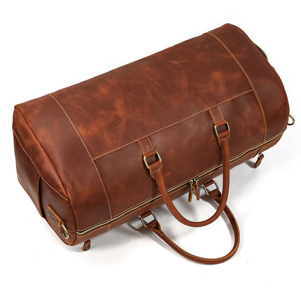 The Weekender 23 Leather Travel Bag is a large, genuine cowhide leather bag featuring sturdy handles, metal hardware, and a zipper closure. It boasts a classic and polished look, along with a shoe compartment, making it perfect for travel or weekend trips.