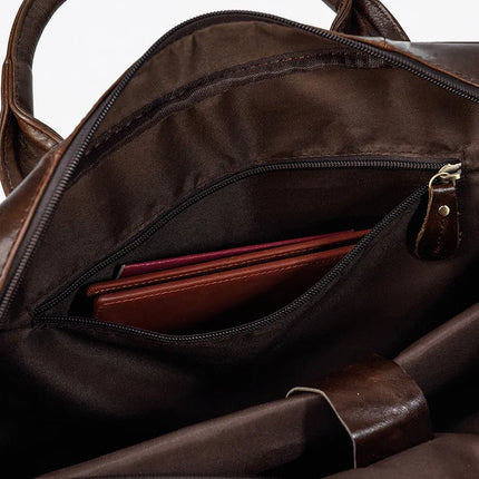 A close-up view of an open Leather 16" Briefcase showcases its interior. Inside, a zippered pocket is visible, containing a red item, possibly a notebook or tablet. The bag’s lining is dark brown, featuring genuine cow leather on the handle and zipper details along with an adjustable strap for convenience.