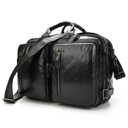 The Leather Travel Backpack Shoulder Bag is a black, versatile accessory crafted from genuine cowhide leather. It features two front zippered pockets, padded shoulder straps, and a top handle. Multiple compartments and silver hardware enhance its sleek and professional appearance, making it the ultimate luxury backpack.