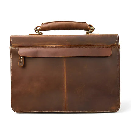 The Leather 16" Business Briefcase is shown, featuring a brown genuine cowhide leather exterior with a smooth finish and visible stitching that exemplifies its simple yet sophisticated design. The briefcase includes a sturdy handle connected by metal attachments and a flap closure for added security. An adjustable strap completes the look.