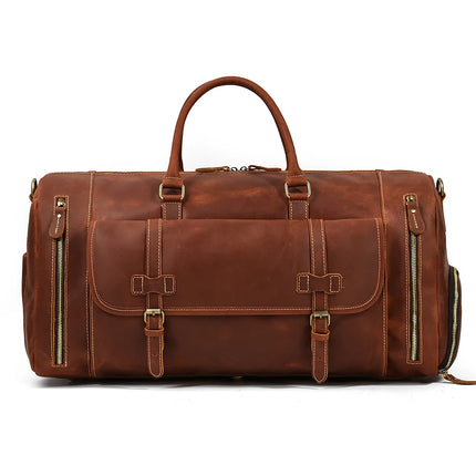 A stylish Weekender 23 Leather Travel Bag in genuine cowhide leather, complete with a polished, rustic finish, is shown. This bag boasts multiple pockets and gold zippers, featuring double handles, a large front pocket with two buckles, side zippered pockets, a shoe compartment, and a detachable shoulder strap.