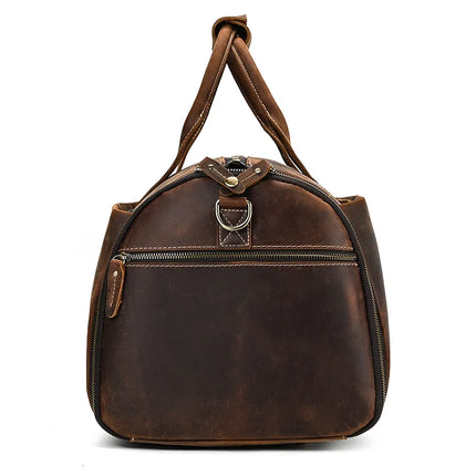 Introducing the Luggage 22 Leather Travel Duffle Bag, a genuine leather travel duffel featuring dual handles and a front zippered pocket. It sports a top zip with metal hardware, along with a worn, vintage look. The bag is slightly tapered towards the top and includes a removable strap for added convenience.