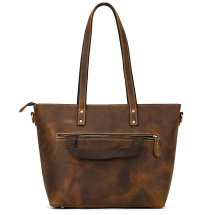 The Genuine Leather Women's Tote Bag – Large Capacity Business Handbag is crafted from authentic brown leather and features long handles and a front zip pocket. Its smooth texture and subtle stitching accents give it an elegant finish, complete with a secure main zip closure at the top.
