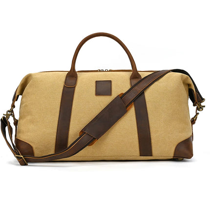 The Canvas & Leather Travel Duffle is a beige and brown bag with genuine leather accents, sturdy handles, and an adjustable shoulder strap. Its vintage design is highlighted by brass hardware and a rectangular leather patch on the front.