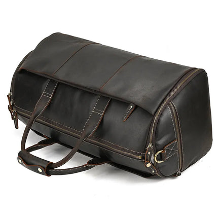 The Luggage 22 Leather Travel Duffle Bag is a sleek, structured large travel bag made from black genuine leather with brown stitching and durable alloy hardware. It features dual handles with a snap closure wrap, a U-shaped zipper opening on top, additional side zippers, and a removable strap for versatile carrying options.