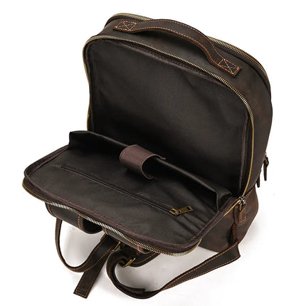 The Vintage Leather Daypack in dark brown features visible inner compartments, including a padded sleeve for a laptop or tablet and an inner zippered pocket. This unisex backpack is crafted from genuine cowhide leather with brass zippers and brown stitching details.