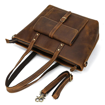 Presenting the Genuine Leather Women's Tote Bag – Large Capacity Business Handbag, crafted with dual handles and a detachable strap. This stylish tote bag includes a front pocket with buckle closure and metal accents. It boasts a rustic finish along with a zippered top opening, delivering vintage charm effortlessly.