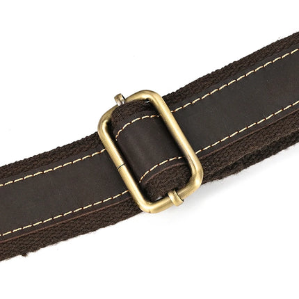 A close-up photo of a dark brown, genuine cowhide leather belt with light stitching, featuring a rectangular brass buckle. The belt's texture and stitching details are clearly visible, echoing the fine finishes of the Dark Brown Leather Shoulder Bag that has alloy hardware.