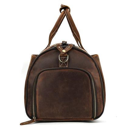 The Luggage 22 Leather Travel Duffle Bag is crafted from genuine brown leather, featuring a front zippered pocket and a clasp detail at the top. This versatile bag includes two top handles, additional zipper details at the sides, and a removable strap for flexible carrying options. Ideal as an everyday travel duffle bag alternative.