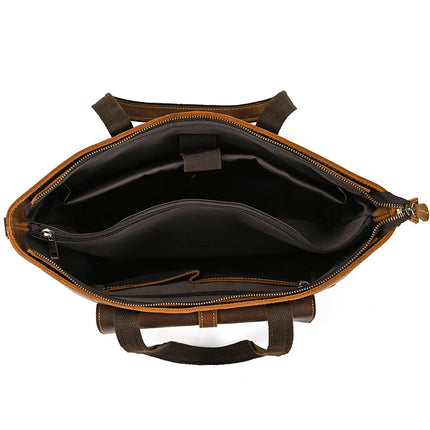 A top-down perspective of the Genuine Leather Women's Tote Bag – Large Capacity Business Handbag showcases its vintage style allure, complete with a dark and roomy interior. The various compartments and zipper pocket provide functional organization, as the elegantly designed handles are prominently displayed on the sides.