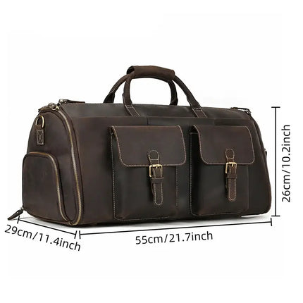 The Weekender 22 Leather Travel Duffle Bag is a large, dark brown genuine cowhide leather duffel bag featuring two buckled front pockets and side zipper pockets. It measures 55cm/21.7 inches in length, 26cm/10.2 inches in height, and 29cm/11.4 inches in width. This travel duffel also comes equipped with handles, a shoulder strap option, and a shoe compartment for added convenience.