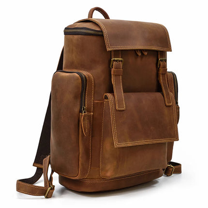 The Vintage Leather Travel Backpack is a stylish bag made from genuine cowhide leather, featuring gold hardware including buckles and zippers. It has a flap closure and multiple pockets on the sides and front, along with adjustable shoulder straps for comfortable carrying. This backpack is perfect for carrying a laptop.