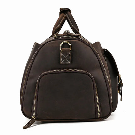 The Weekender 22 Leather Travel Duffle Bag is crafted from dark brown, genuine cowhide leather and features gold zippers and metal loop details. It includes a large zippered pocket on the front, a top handle, and adjustable shoulder straps. This sleek, minimalist design with visible stitching makes it an ideal choice for your weekend travels.