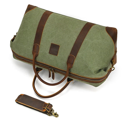 The Canvas & Leather Travel Duffle is a vintage green fabric bag with brown genuine leather accents and handles, featuring a detachable shoulder strap and visible zipper.