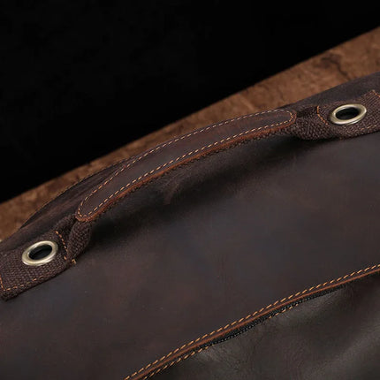 Close-up of a dark brown, genuine cowhide leather handle with metal eyelets on a brown background, part of the Vintage Leather Travel Backpack. The handle features double stitching and showcases a rugged, well-crafted design, perfect for the stylish traveler.
