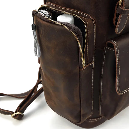 A close-up of the Vintage Leather Travel Backpack features an open side pocket that contains a white cylindrical item, securely held by a brass zipper. The bag's meticulous stitching and durable straps are prominently visible, emphasizing its exceptional craftsmanship and design. The genuine cowhide leather enhances its timeless charm.