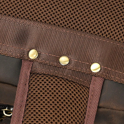 Here's a close-up of the brown fabric surface on the Vintage Leather Travel Backpack for men. It features a mesh panel and leather trim, with three metal rivets evenly spaced along a horizontal strap, adding a sturdy, decorative touch to its vintage style. The texture beautifully combines smooth genuine leather with airy mesh.