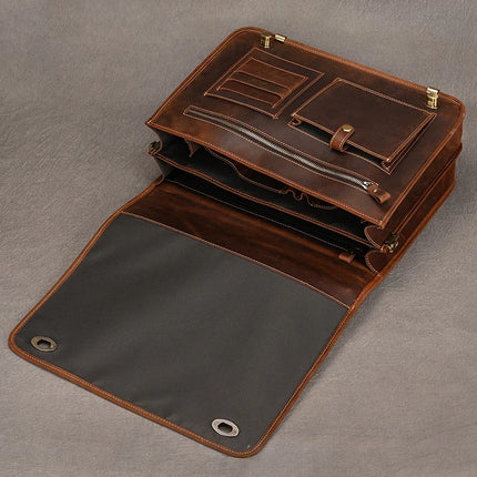 The Vintage Business Travel Briefcase is open, revealing its compartments and pockets, which include card slots, a zippered pocket, and a main compartment with additional sections. The interior of the bag is lined with black fabric, metal grommets are visible on the front flap, and an adjustable strap enhances comfort.