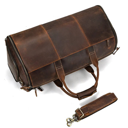 The Luggage 22 Leather Travel Duffle Bag is a spacious, dark brown leather duffel featuring two sturdy handles and contrasting stitching. It has a zippered closure along with a removable shoulder strap made of genuine leather, positioned beside the bag. This minimalist design makes it ideal for travel or daily use.